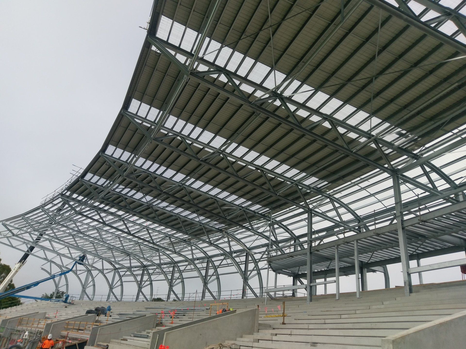 A large metal structure is being built on top of a stadium.