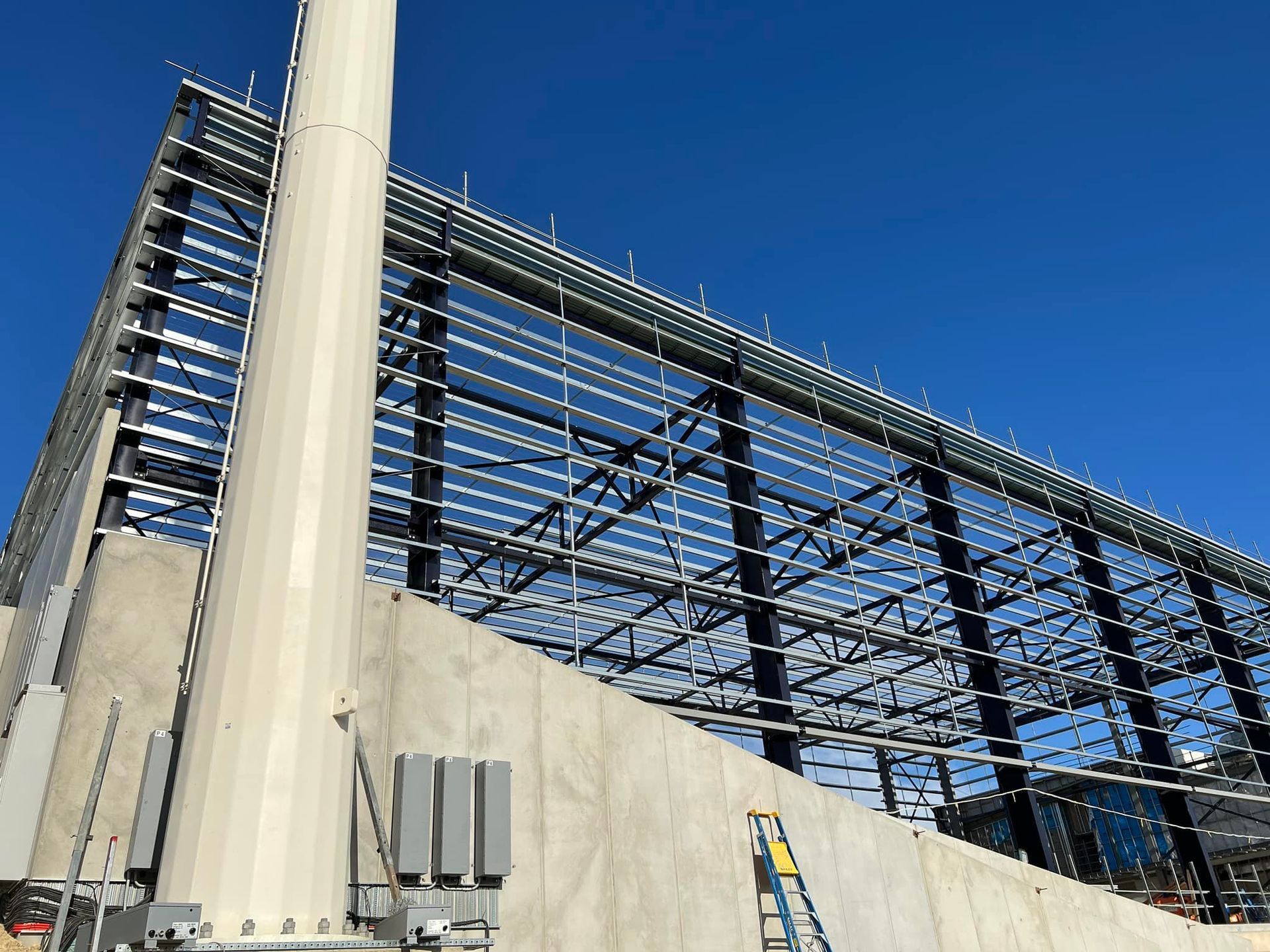 A large building under construction with a blue sky in the background