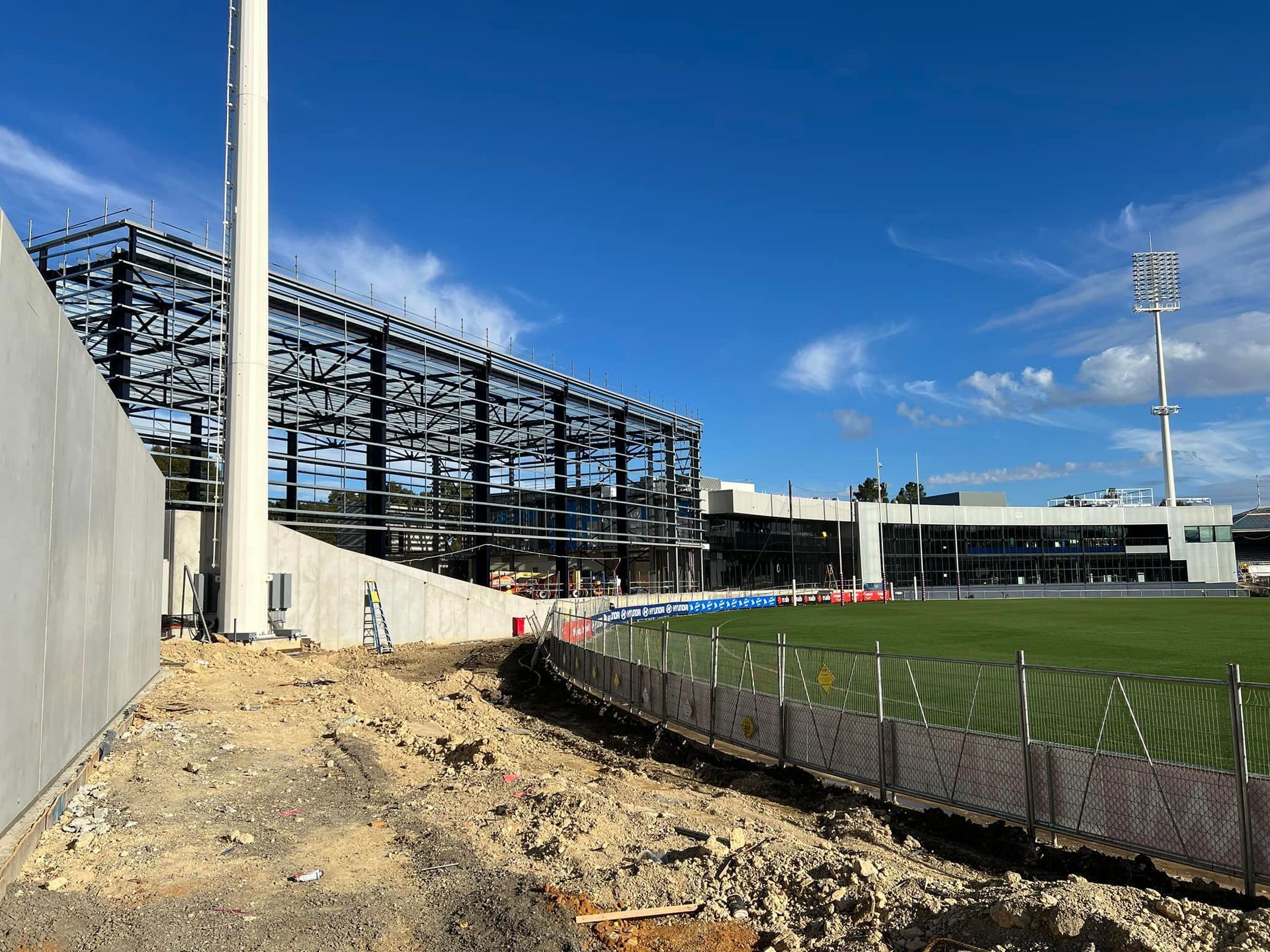 A stadium under construction with a fence in front of it.