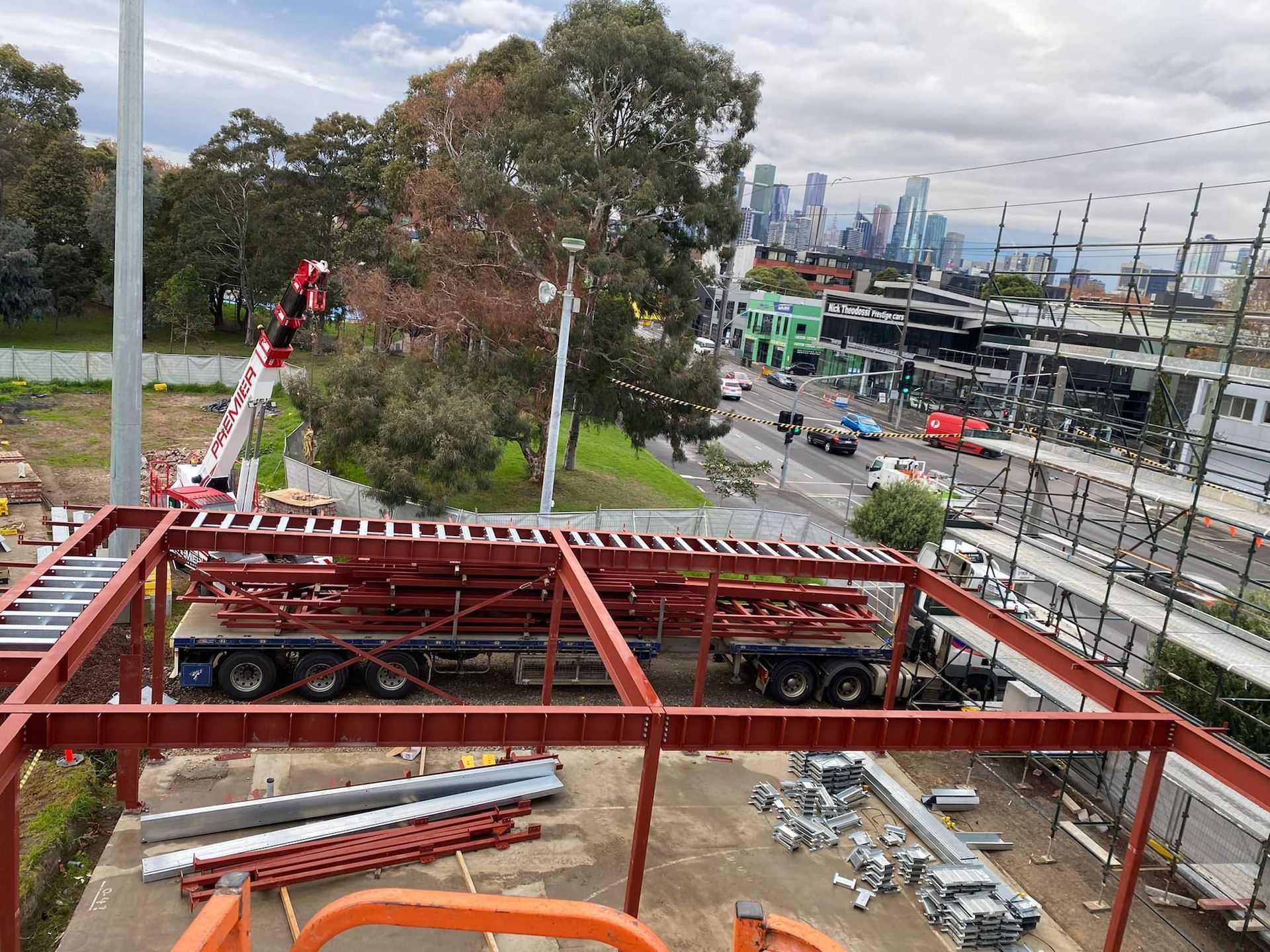 An aerial view of a construction site with a city in the background.