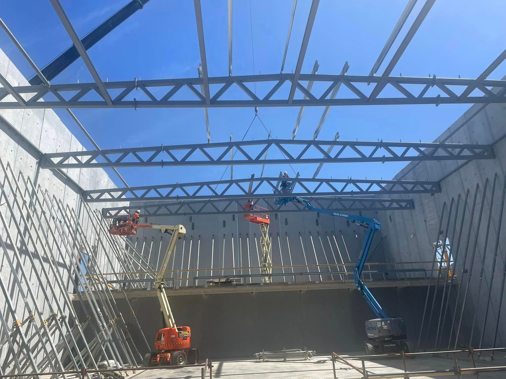 A large building under construction with a blue sky in the background