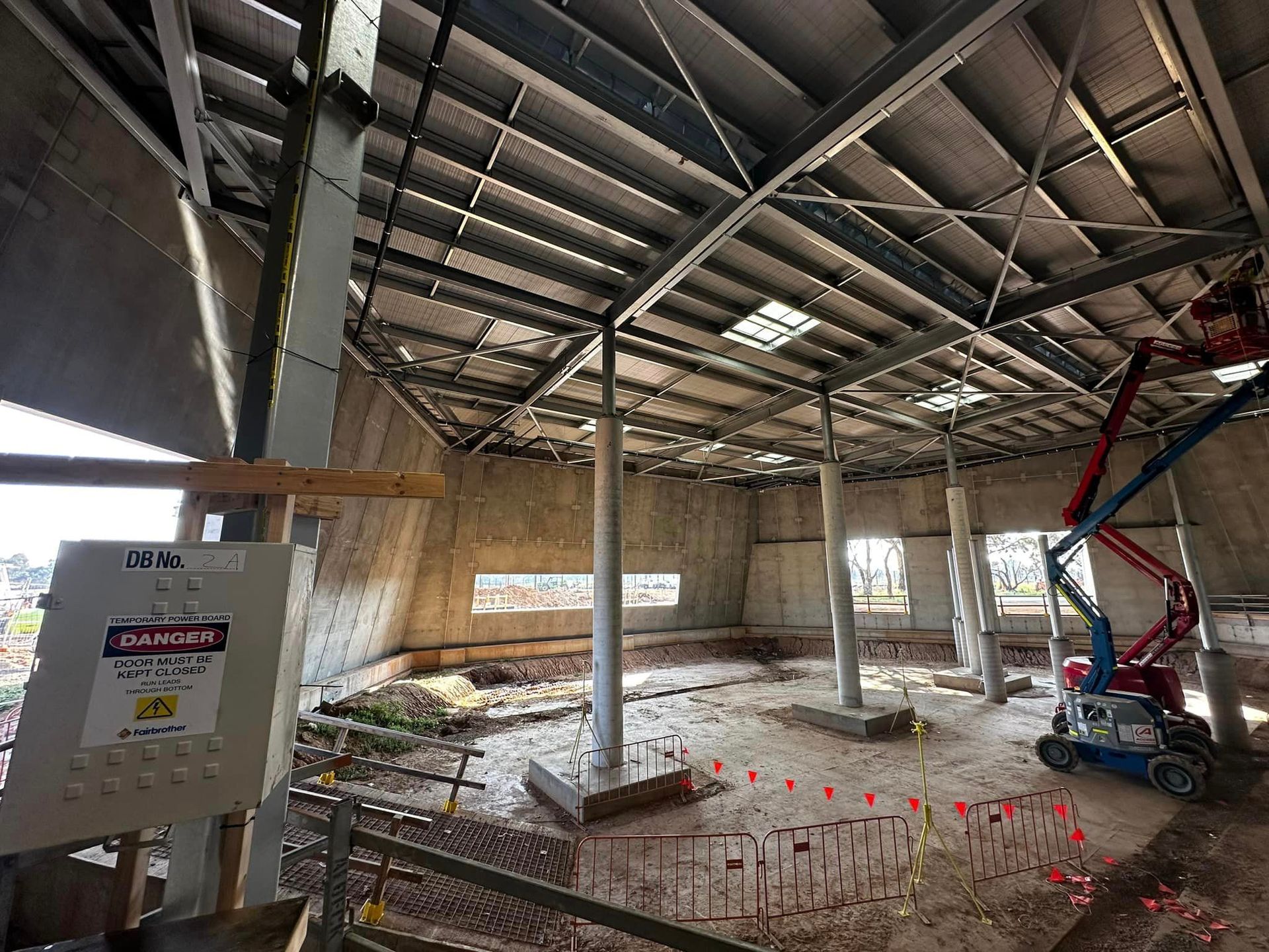 A large building under construction with a crane in the background.