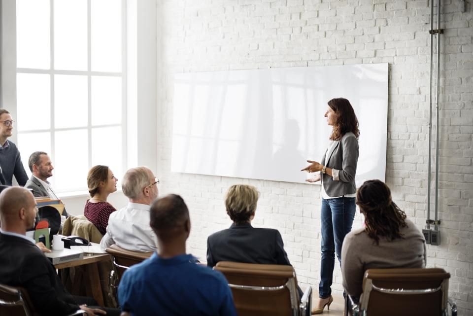 a lady teaching to the team members