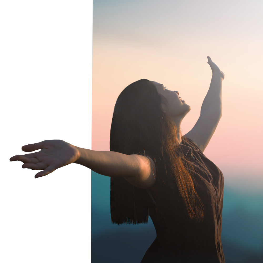 A woman is standing with her arms outstretched in the air.