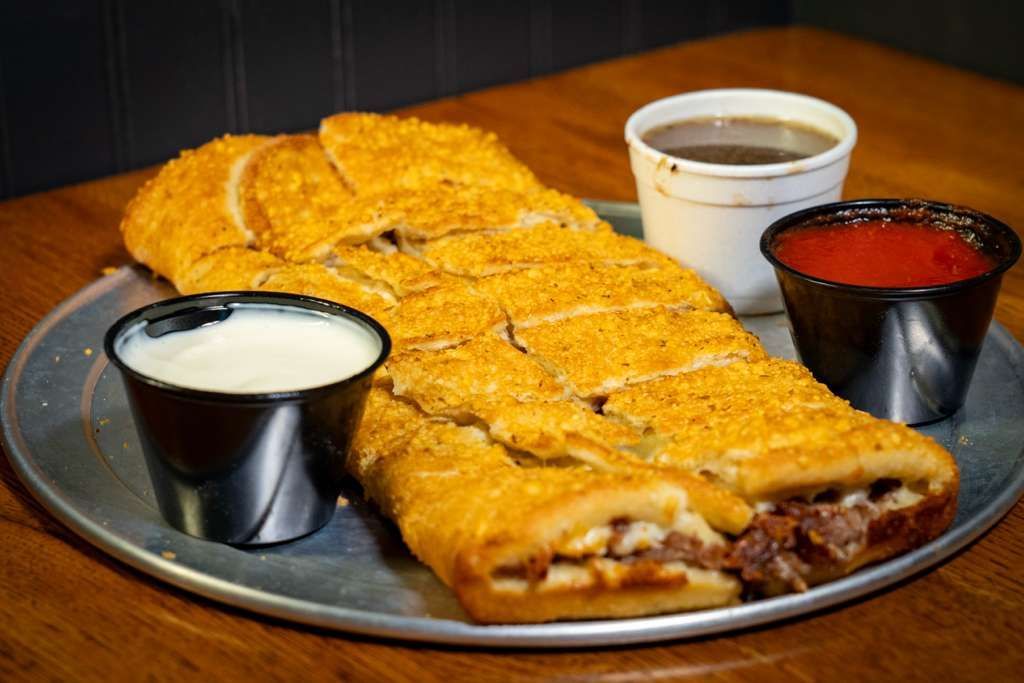 Beef Roll, Sliced Italian beef smothered in our signature cheese blend, wrapped in a golden, crispy crust. 