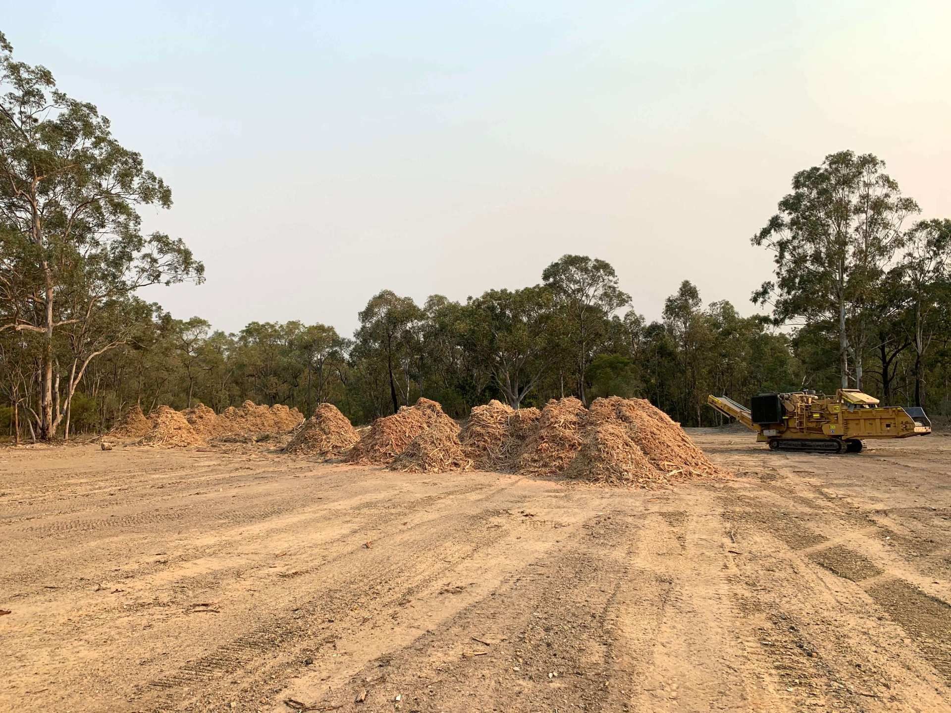 A large pile of dirt is sitting in the middle of a dirt field.
