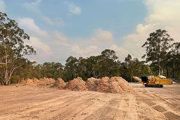 A large pile of dirt is sitting in the middle of a dirt field.