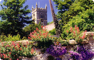 Old stone clock tower in lovely gardens
