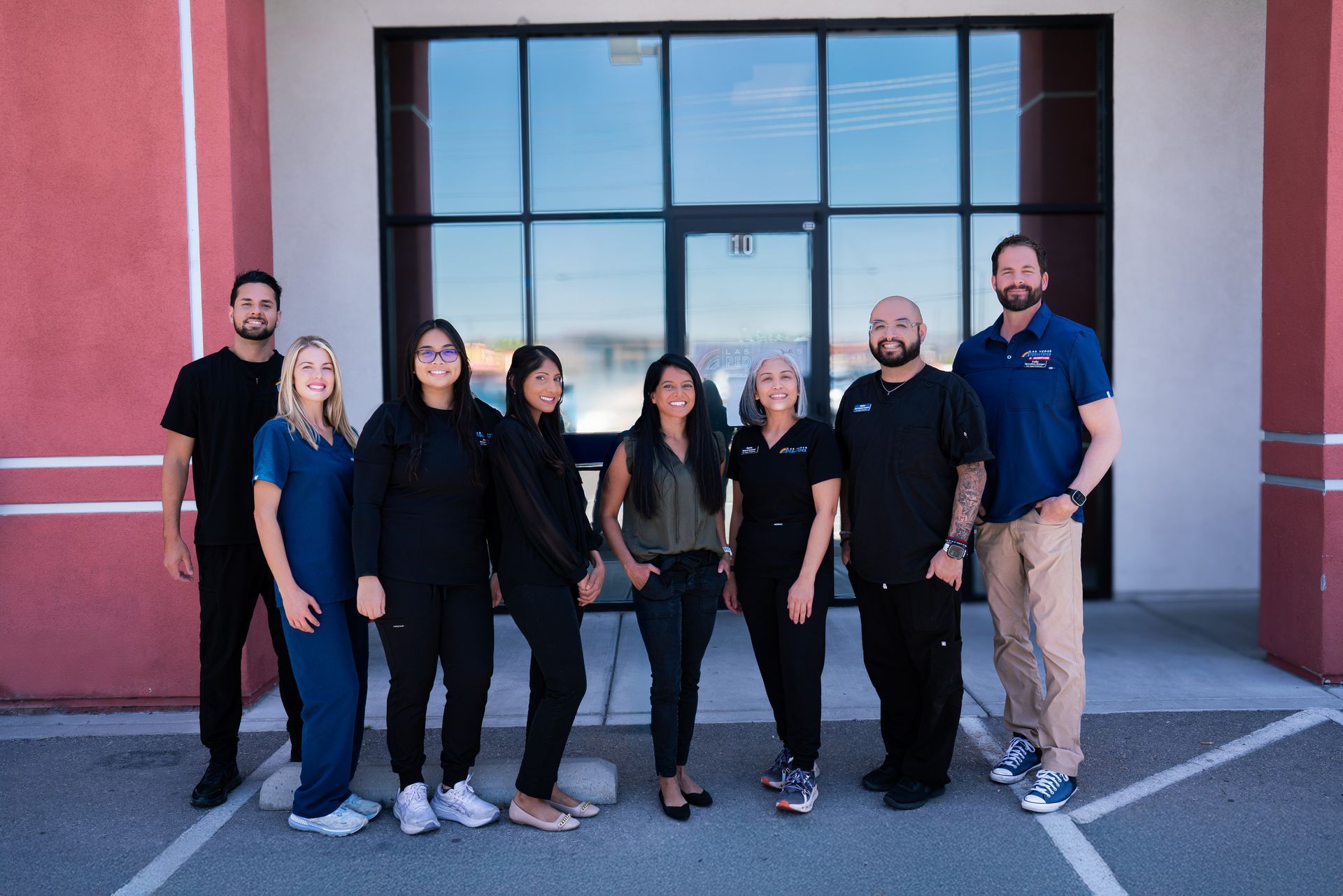 Outside location of Las Vegas Pediatrics + Urgent Care with staff in front of building.