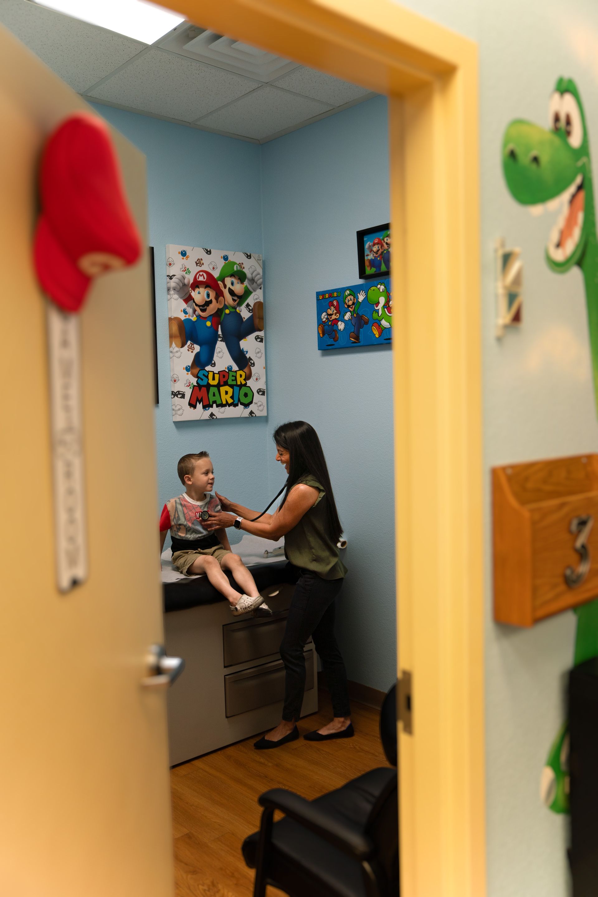 A baby is being examined by a doctor with a stethoscope.