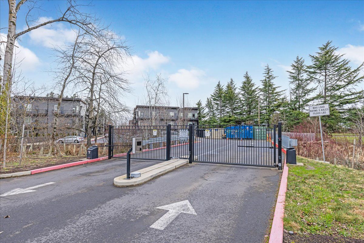 a gated entrance to a parking lot with an arrow pointing to the right .