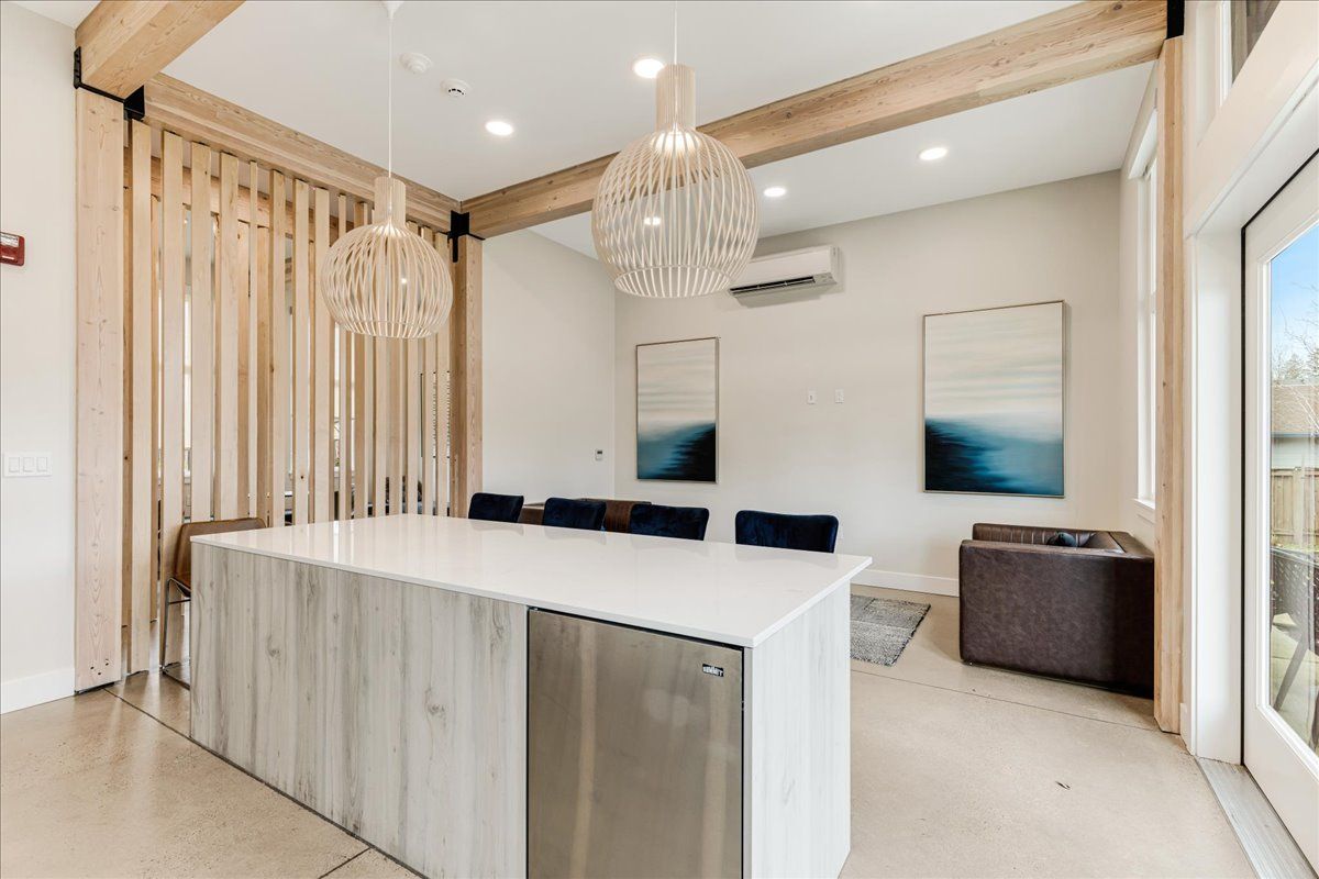 there is a large island in the middle of the room .