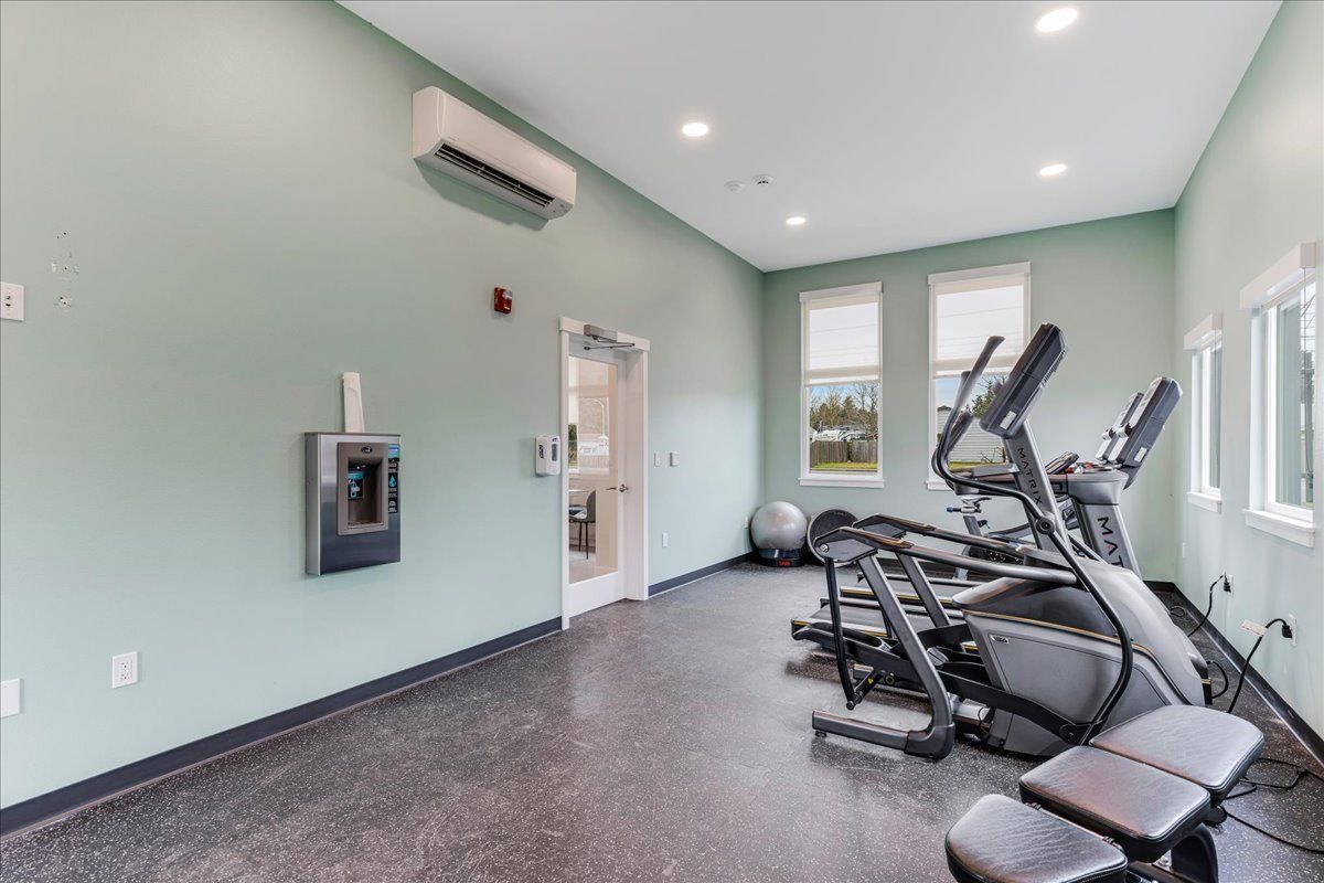 a gym with a lot of exercise equipment in it