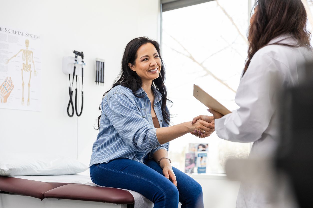 Holistic women’s health - Female patient consulting with a female doctor inside a hospital.