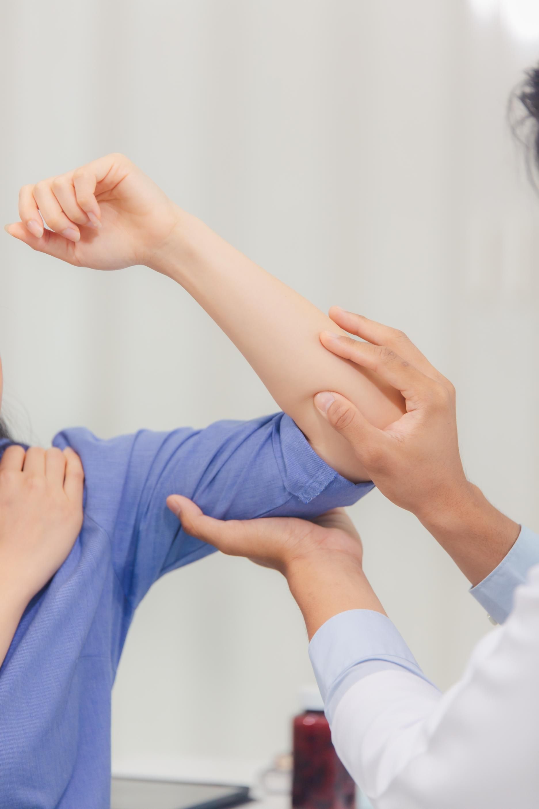 A person's arm being examined by a doctor.