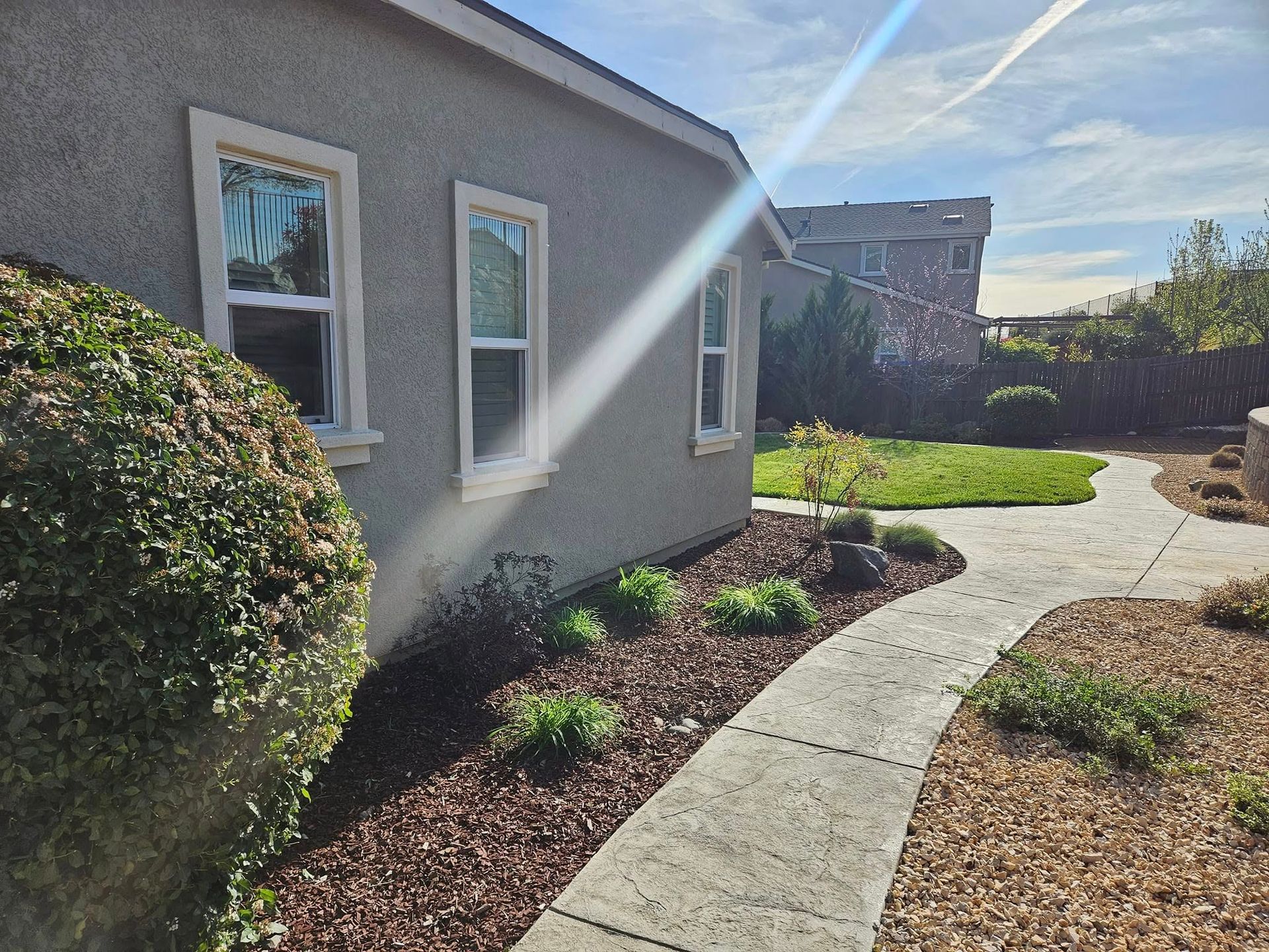 A house with a concrete walkway leading to it