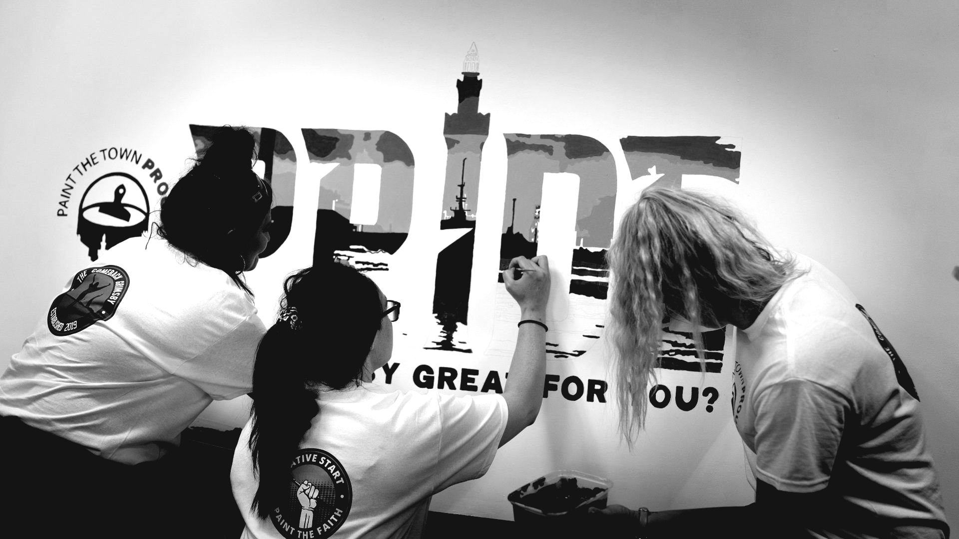 Three people painting a