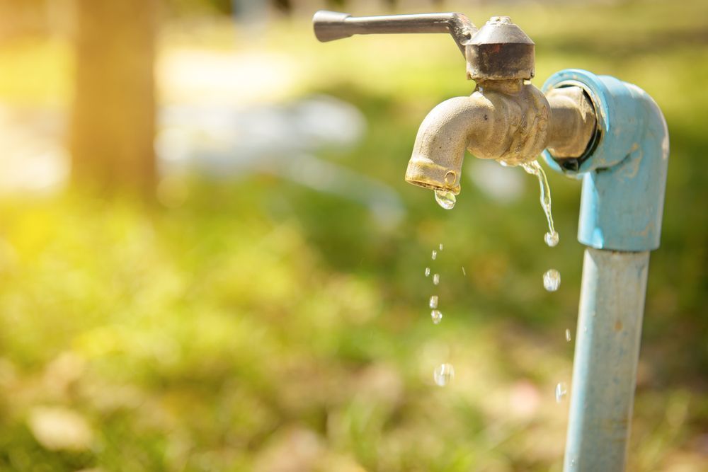 A Close Up of a Faucet With Water Dripping Out of It — Pimlico Plumbing in Mount Louisa, QLD