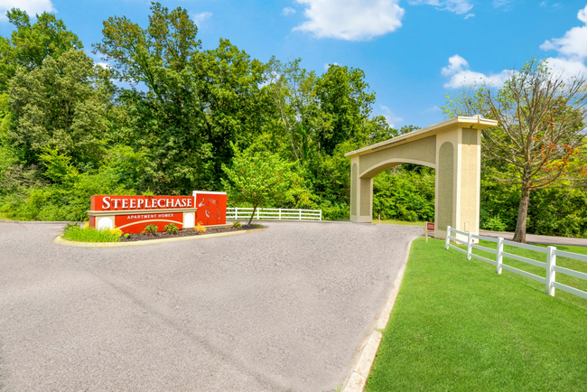 A gated entrance to a residential area with a sign that says steeplechin.