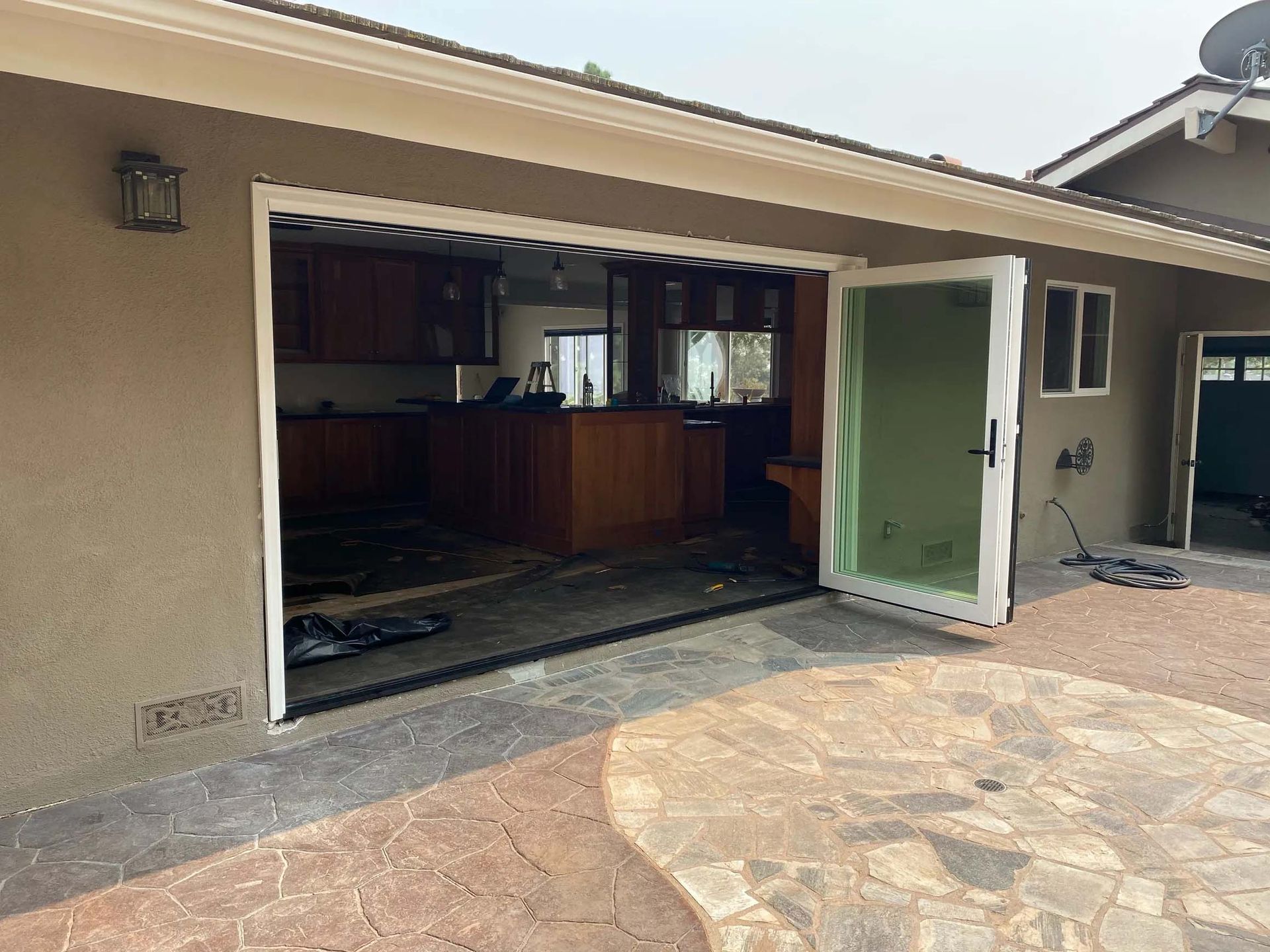 A house with a garage door open to a kitchen.