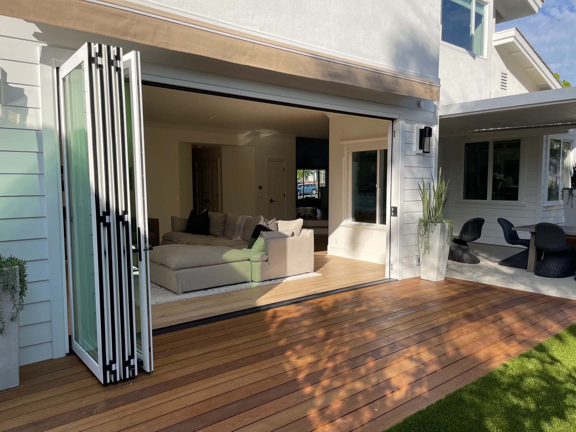 A house with a large sliding glass door that opens to a patio.
