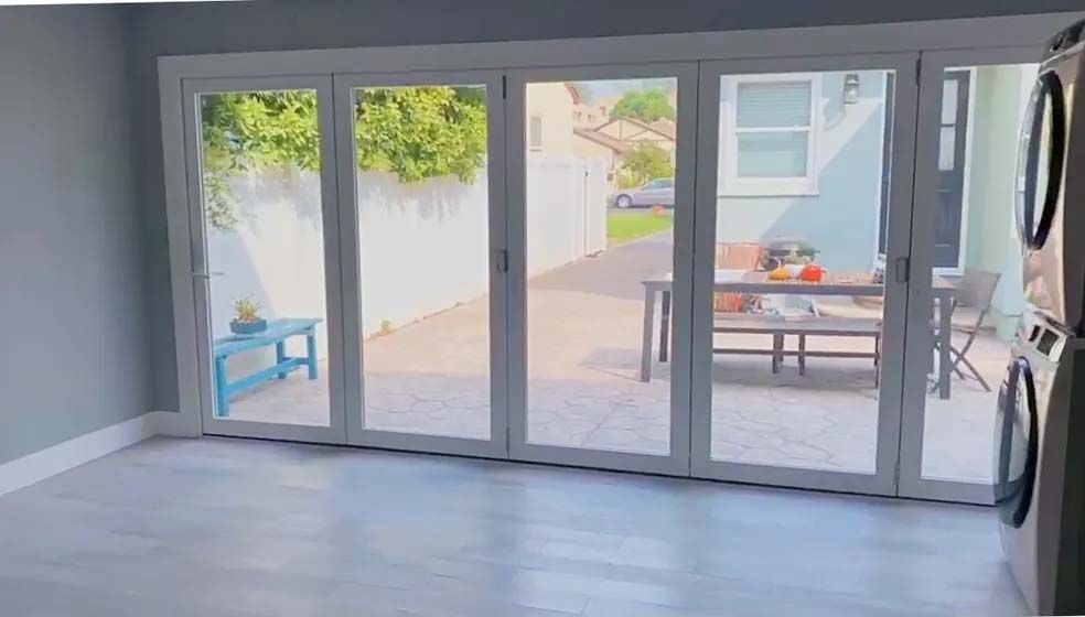 A living room with sliding glass doors leading to a patio.