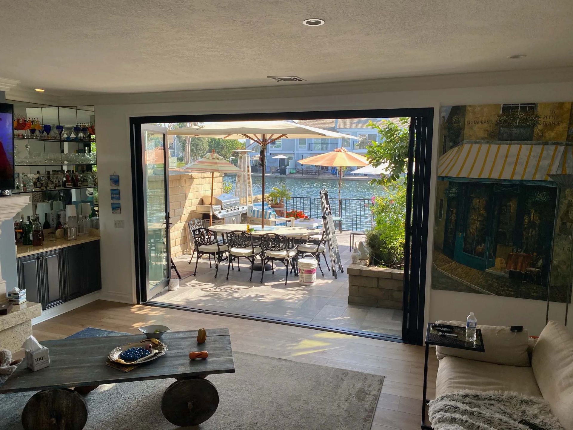 A living room with a couch , coffee table , and sliding glass doors leading to a patio.