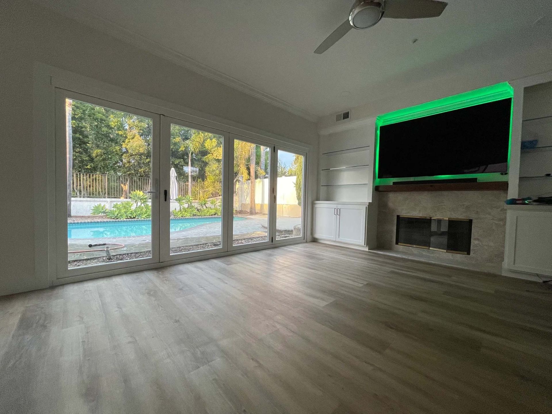 A living room with a fireplace and a flat screen tv.