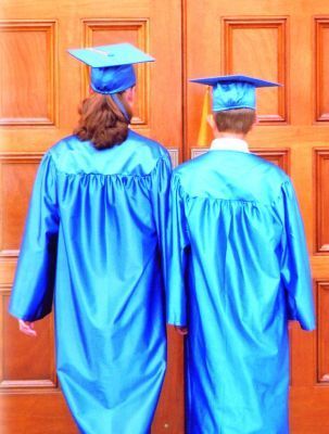 two graduates in blue gowns are standing in front of a door