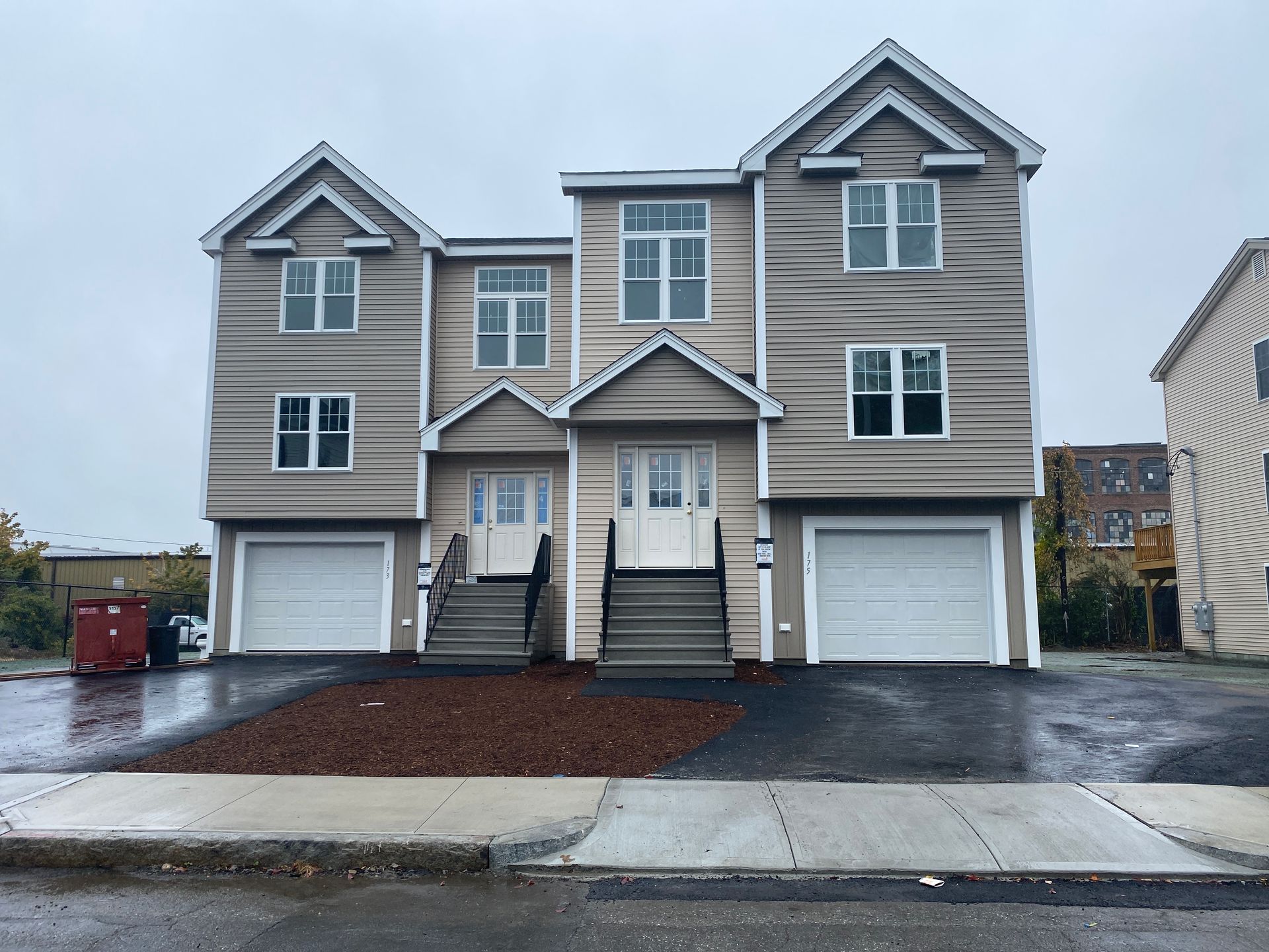 A large house with two garages and stairs