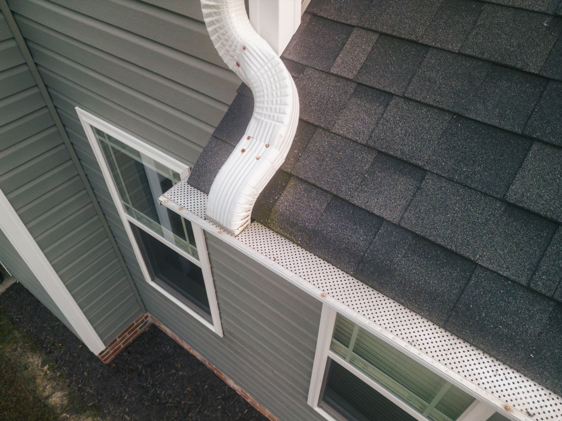 An aerial view of a house with a gutter on the side of it.