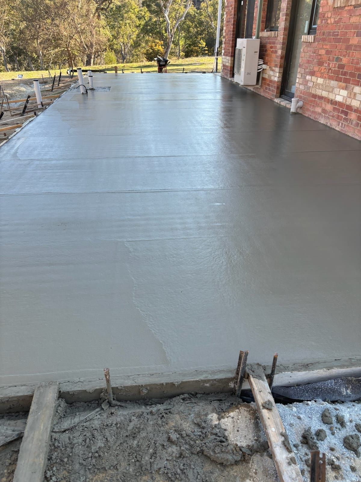 Concrete Slab Beside Brick House — Tiger Concrete ACT In Fadden, ACT