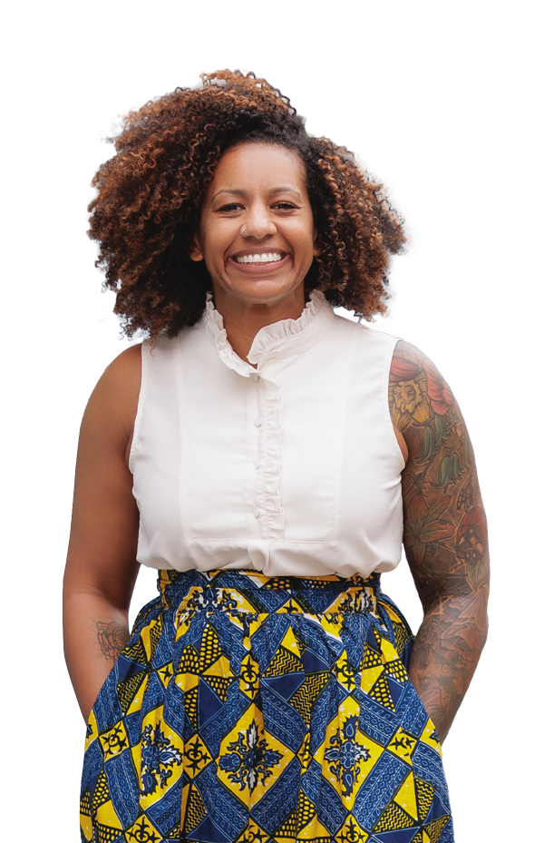 Photo of Dr. Jen Fry, a Black woman with an afro and tattoos on her arms, smiling. She has on a white sleeveless button-down shirt and a blue and yellow print skirt.