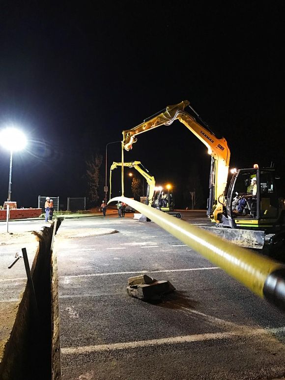 excavator in action at night