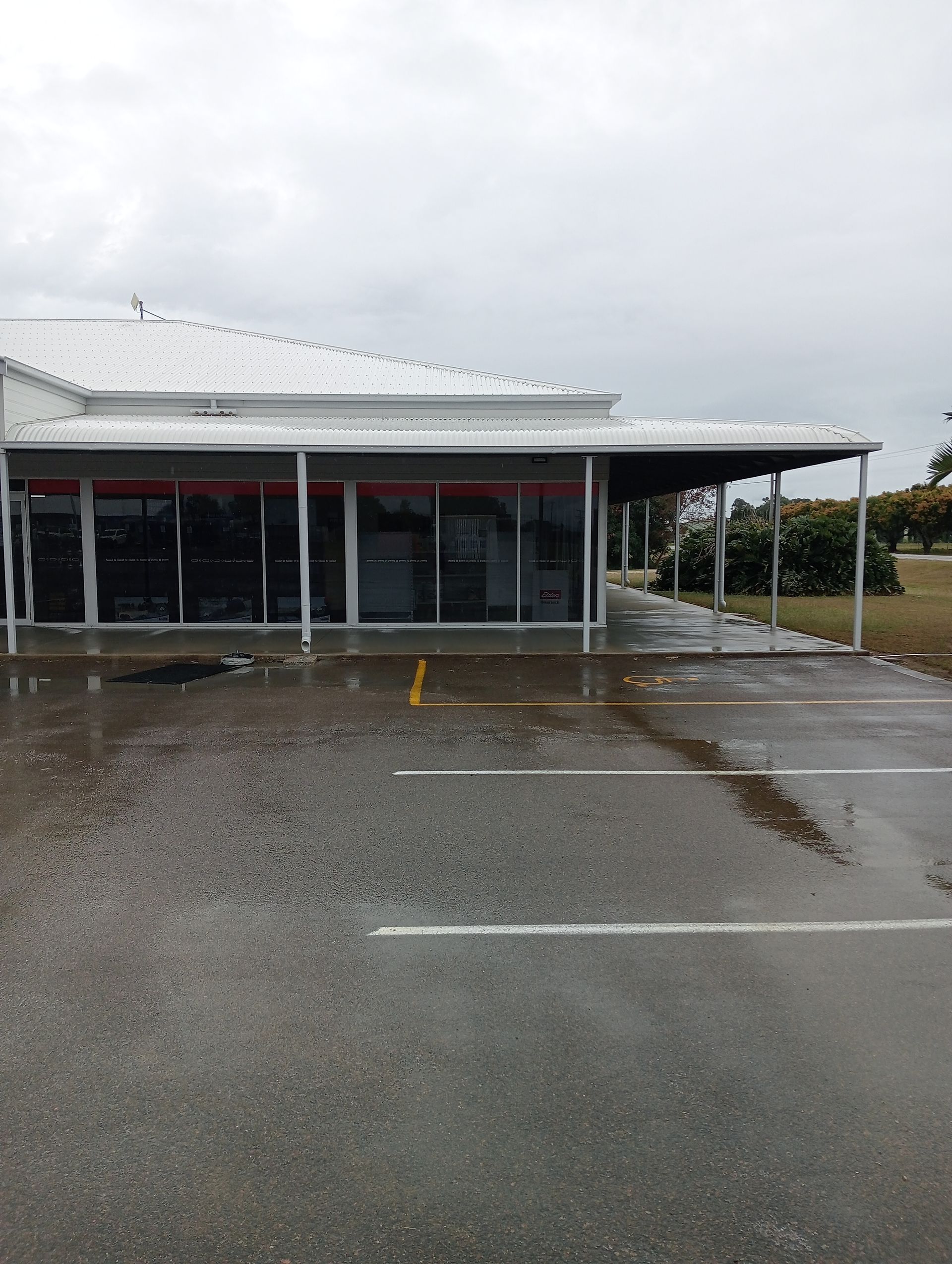 Building With Large Glass Windows and a Covered Walkway — All Sparkles Cleaning Technology In Ayr, QLD