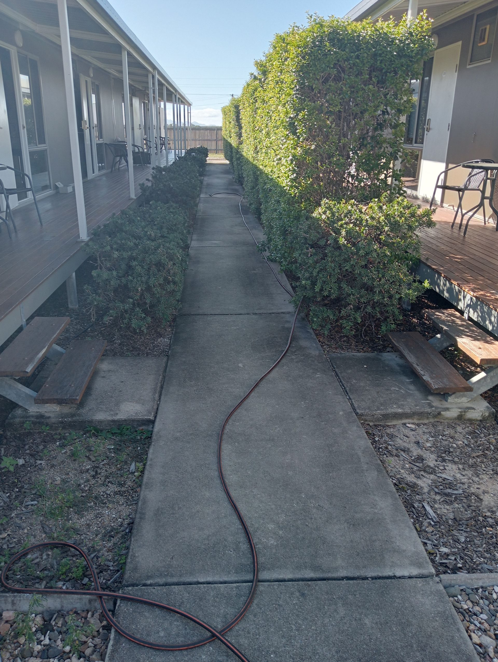 Concrete Walkway Between Two Buildings Lined — All Sparkles Cleaning Technology In Collinsville, QLD