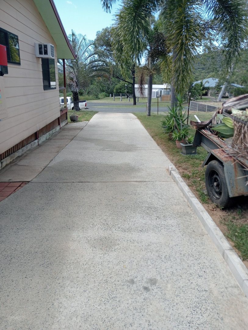 Concrete Driveway Next to A Light-Colored Building — All Sparkles Cleaning Technology In Bowen, QLD