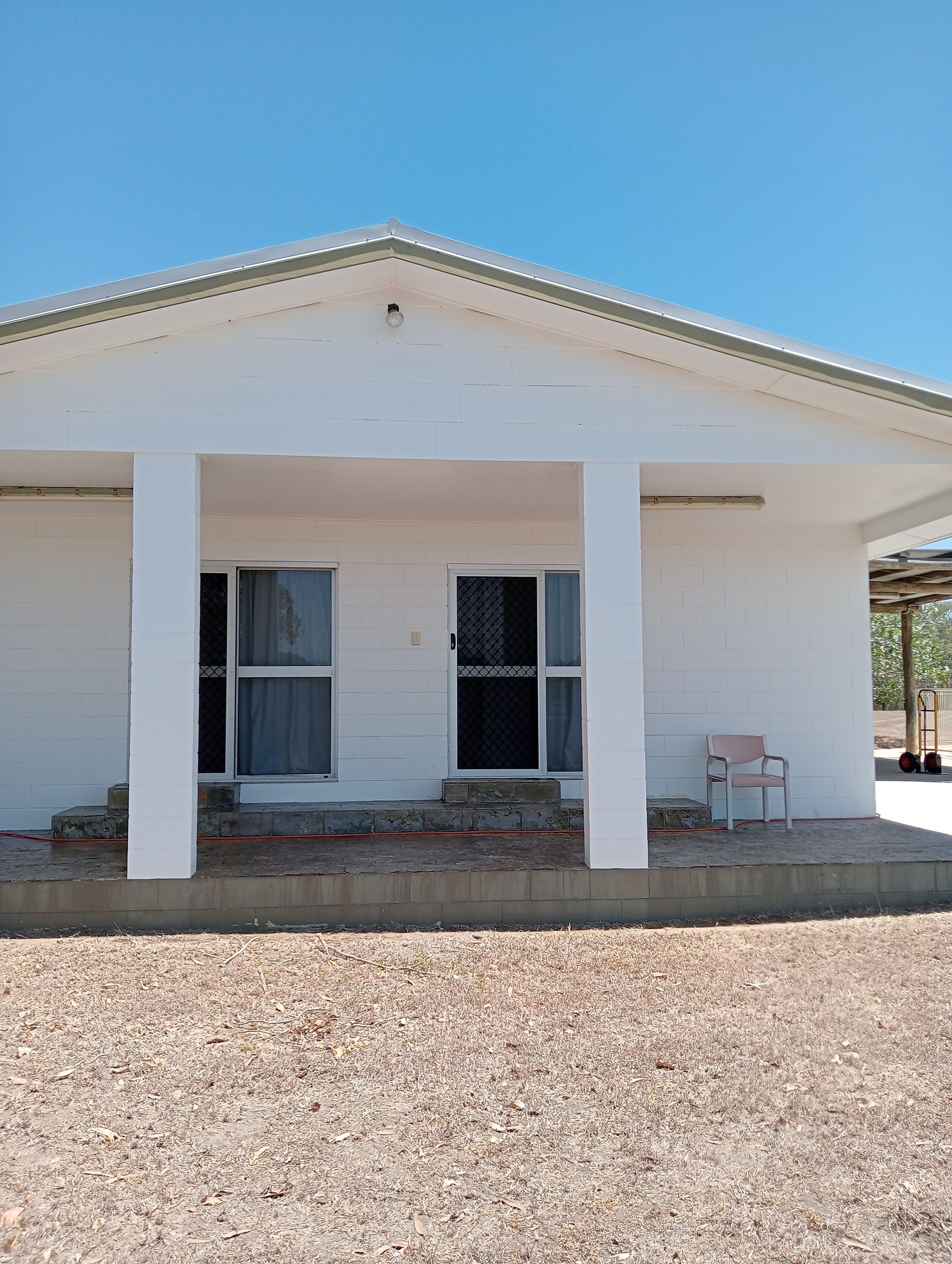 Garage With Painted Doors, Potted Plants — All Sparkles Cleaning Technology In Bowen, QLD
