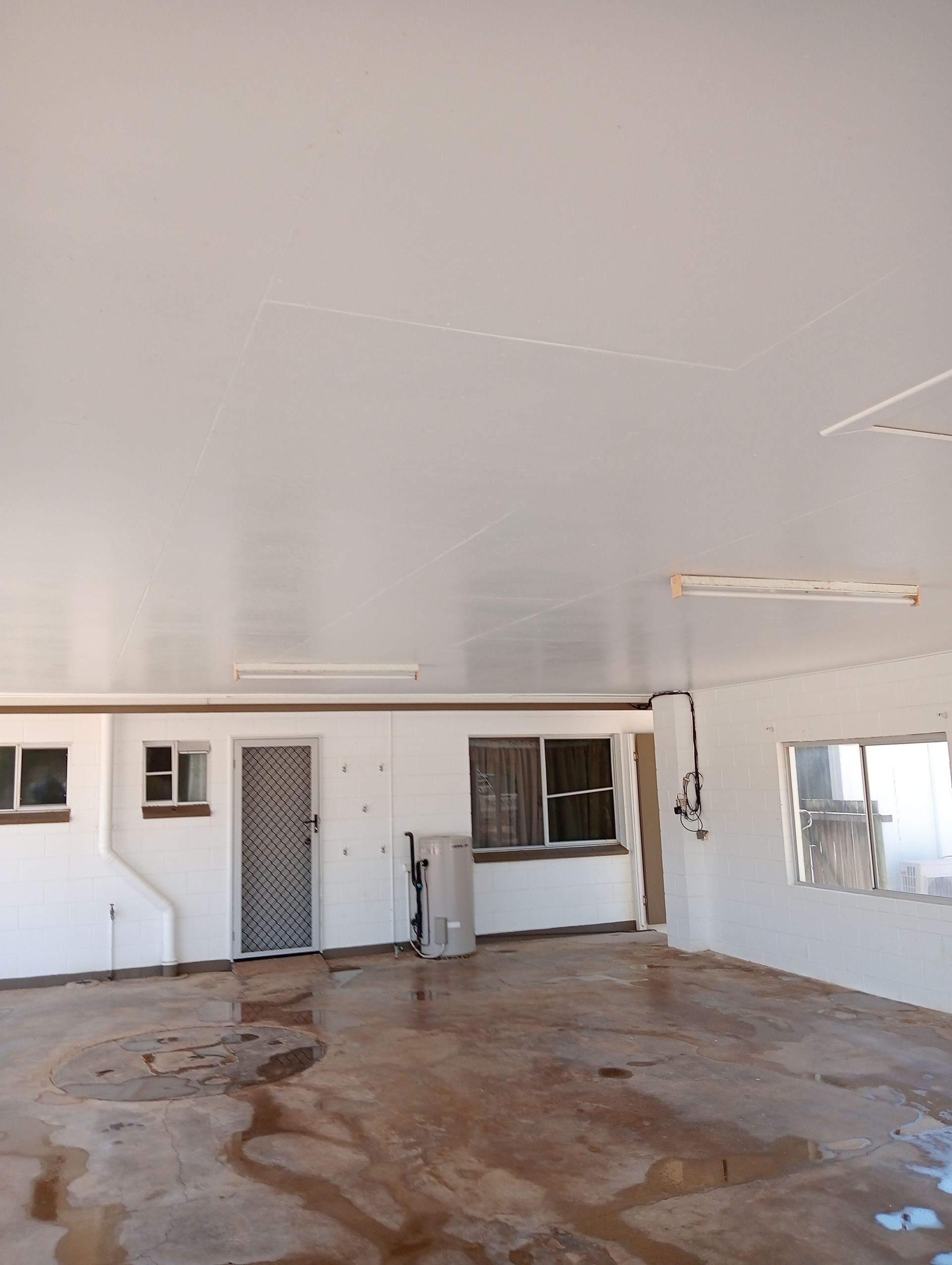 Empty, Wet-floored Interior of a Building — All Sparkles Cleaning Technology In Bowen, QLD