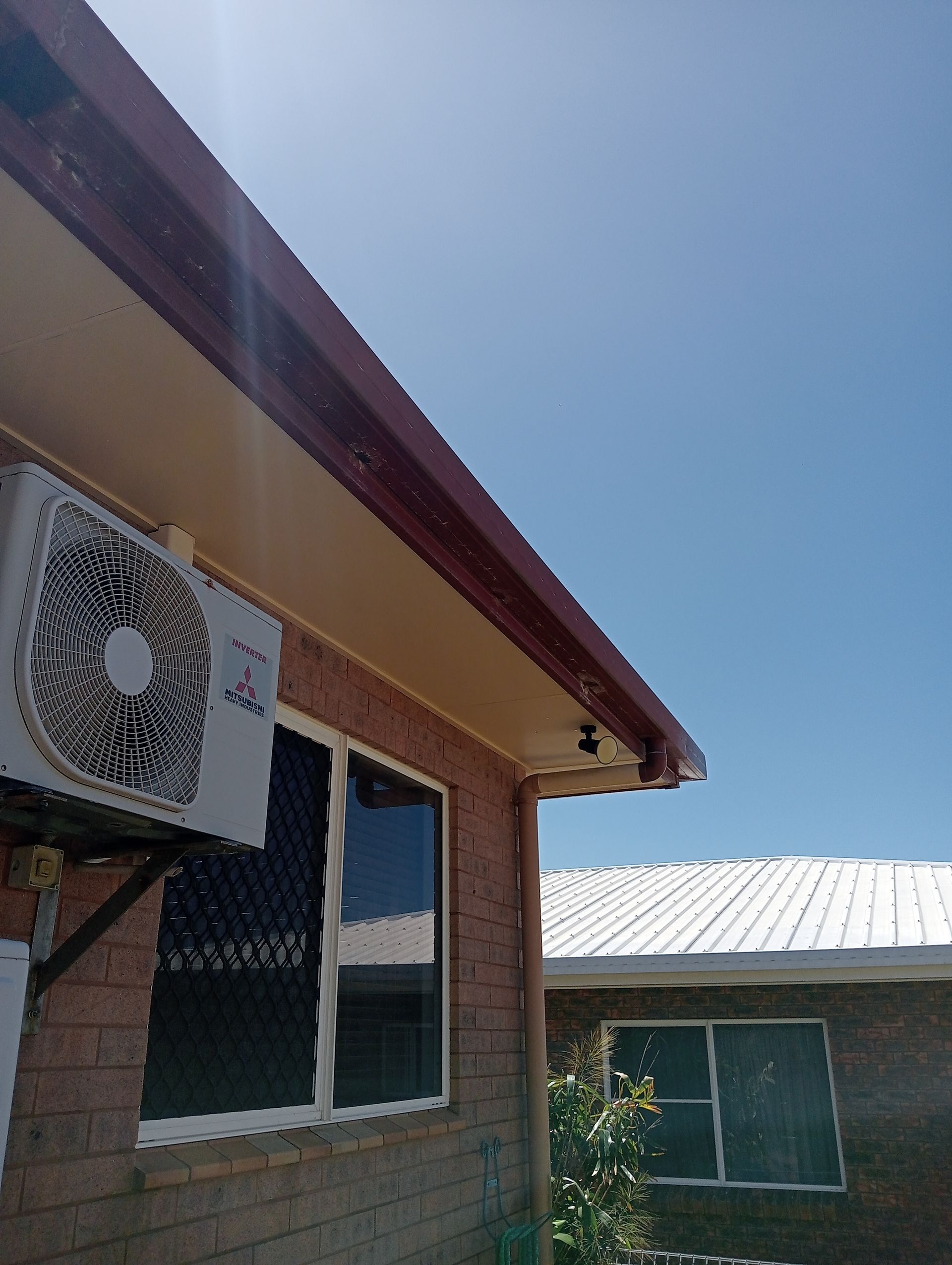 Exterior View of a Brick Building With a Mounted Air Conditioning Unit — All Sparkles Cleaning Technology In Bowen, QLD