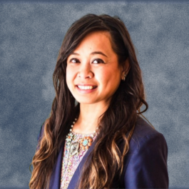 A woman with long hair is wearing a blue jacket