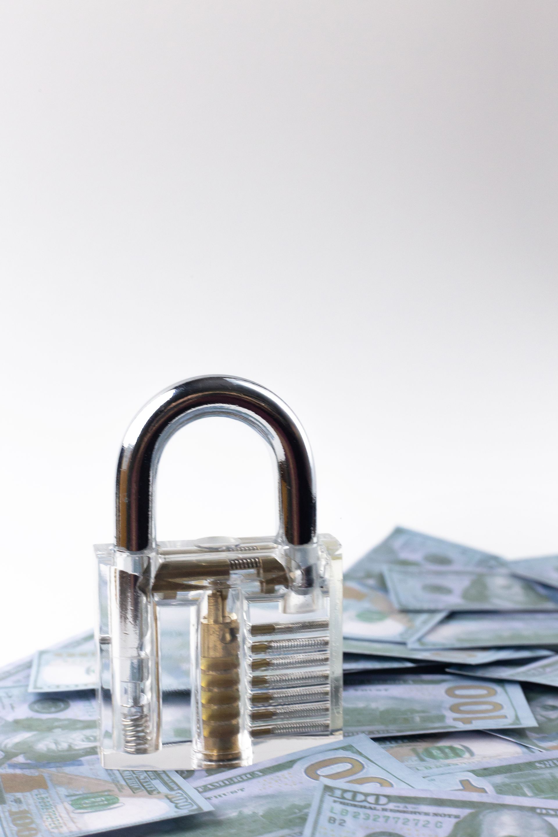 A man is kneeling down next to a car with a red light on it.