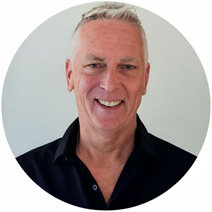 A man in a black shirt is smiling for the camera