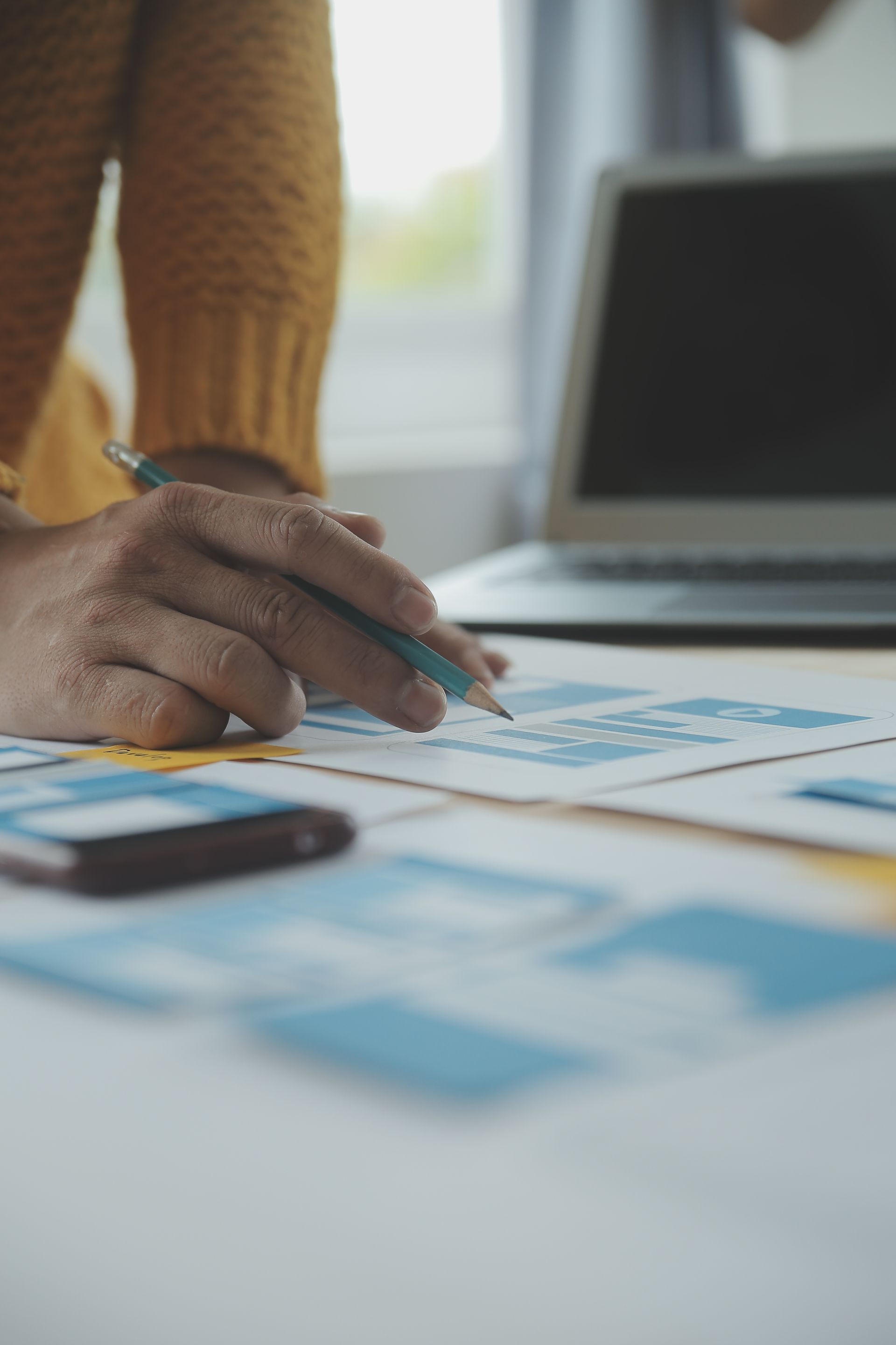 A man is riding a bike on a road in the woods.