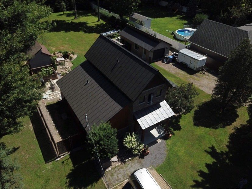 Une vue aérienne d'une maison avec un toit noir