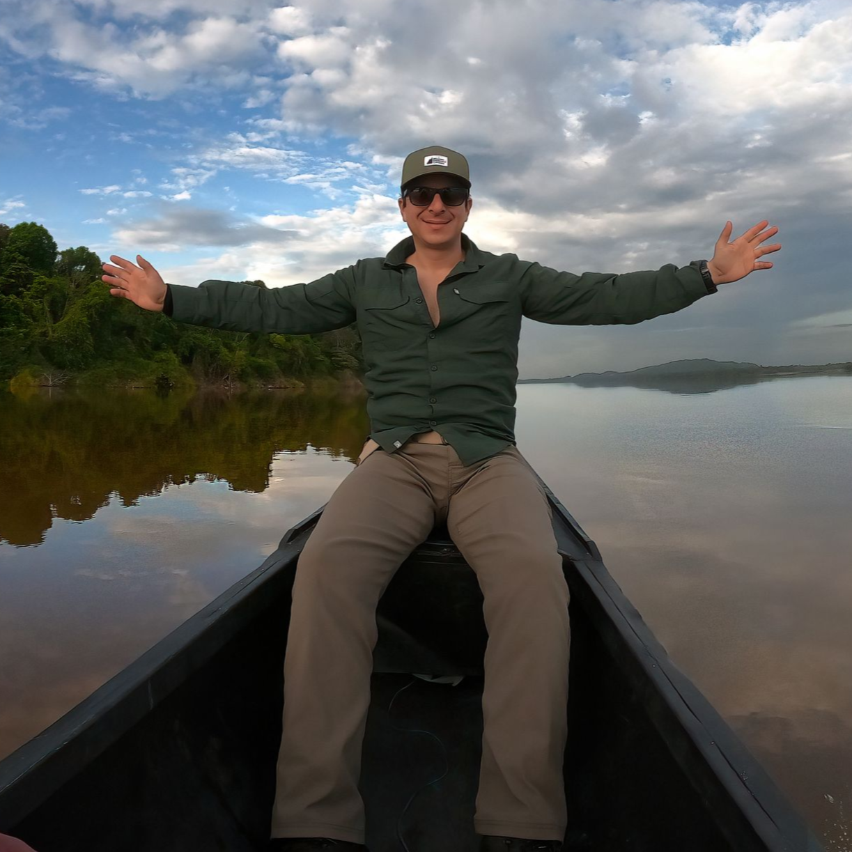 A man wearing a hat and a jacket is taking a selfie