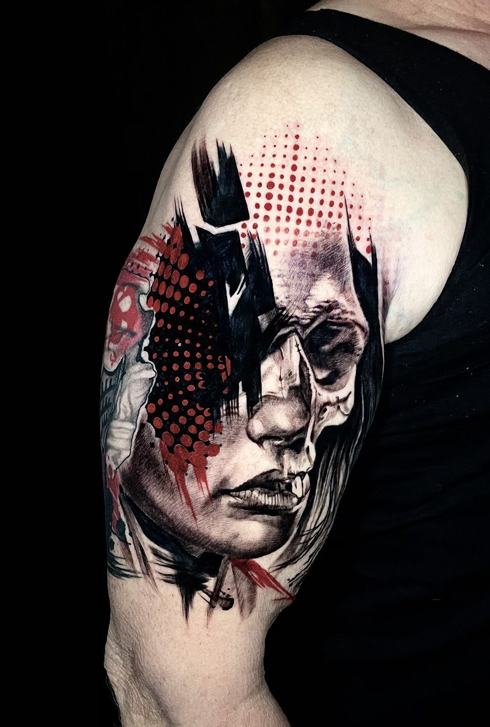 A woman has a tattoo of a skull on her arm.