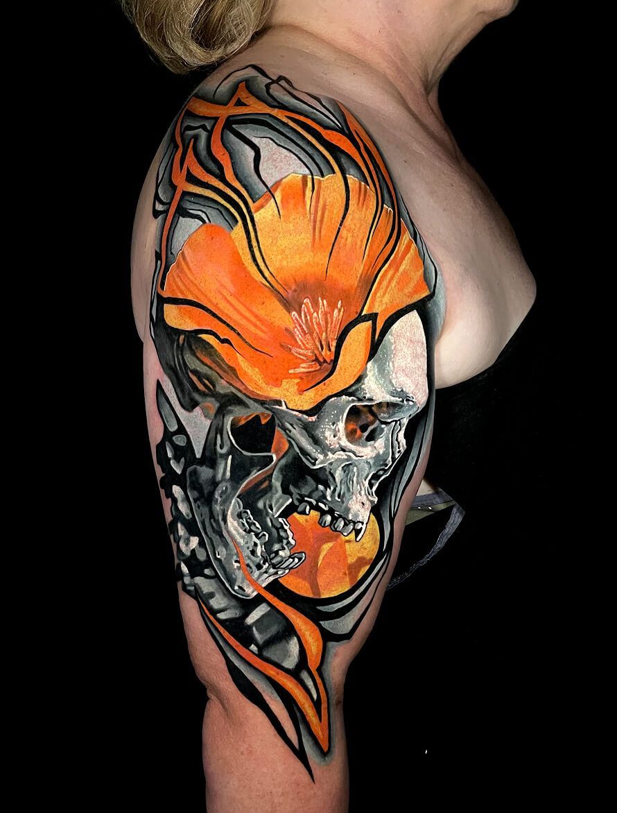 A woman has a tattoo of a skull and a flower on her shoulder.