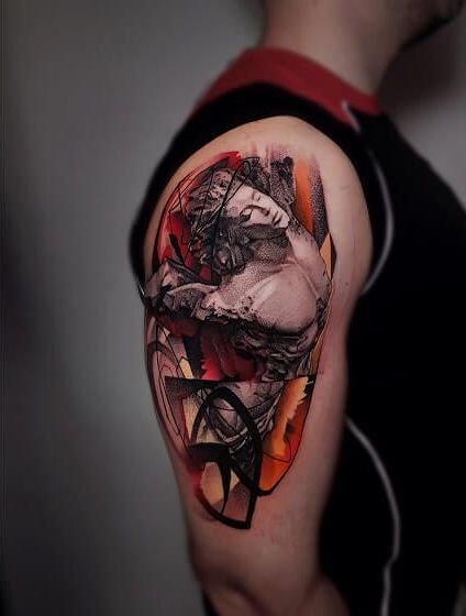 A man has a tattoo of a statue on his arm.