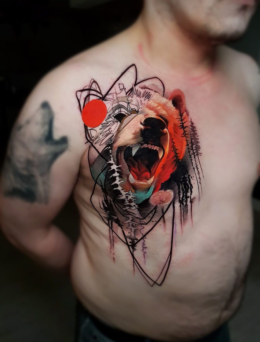 A man has a tattoo of a bear on his chest